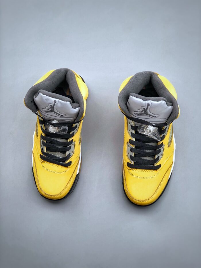 Yellow high-top sneakers with black laces and grey accents.