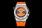 A sporty watch with an orange rubber strap and a black dial featuring white markings and three sub-dials.