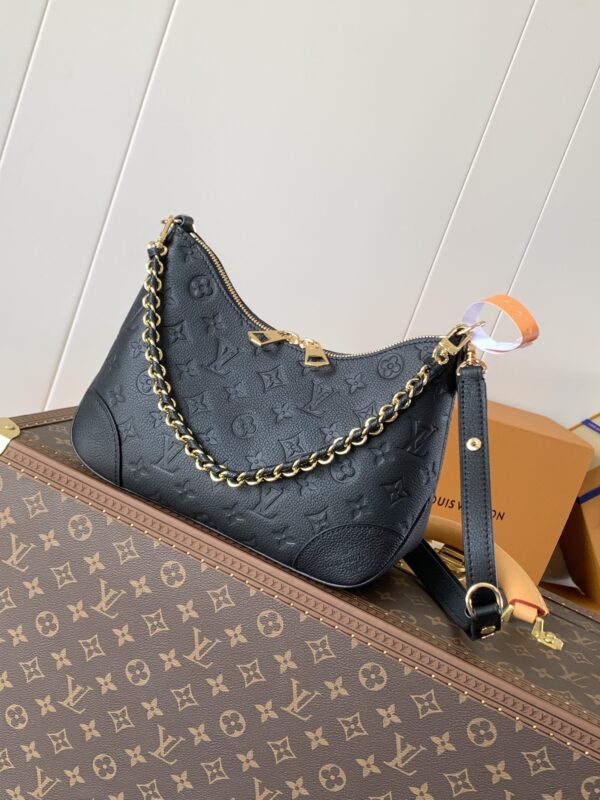 Dark blue classic pattern handbag with gold chain, black strap, and brand box